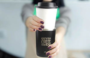 Woman Holding Coffee Cup and Sleeve with Custom Engraved Company Logo